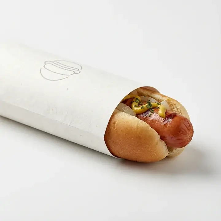 Paper hot dog wrappers and sleeves with hot dogs