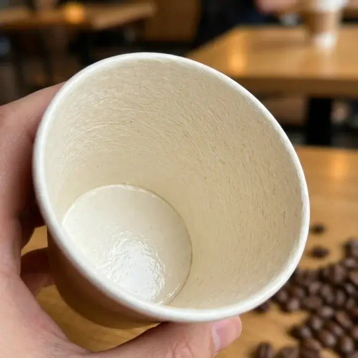 Detailed view of a reinforced single-wall cup seam and leak-proof rolled rim construction